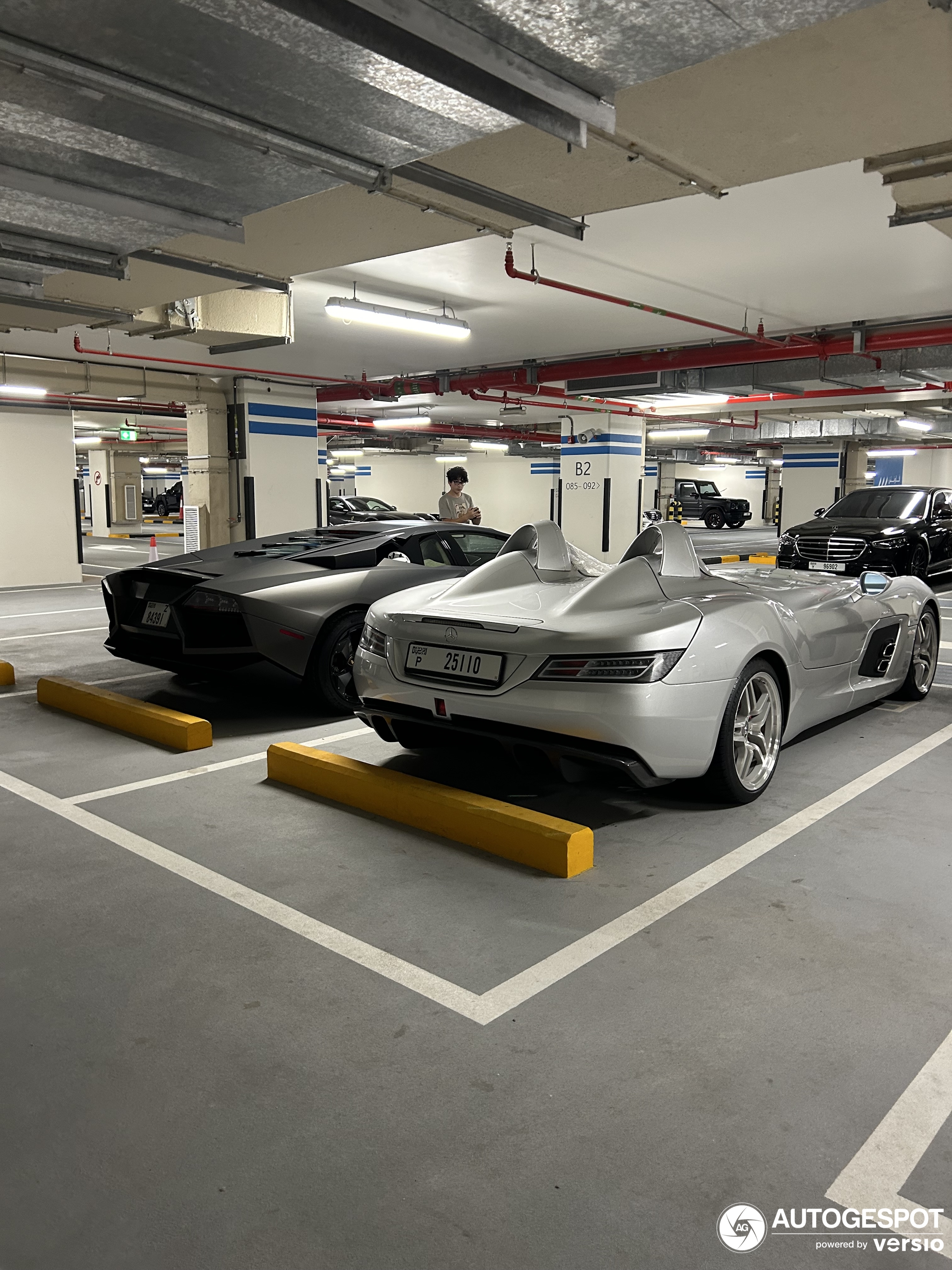 Two legendary cars are standing together in an underground garage in Dubai.