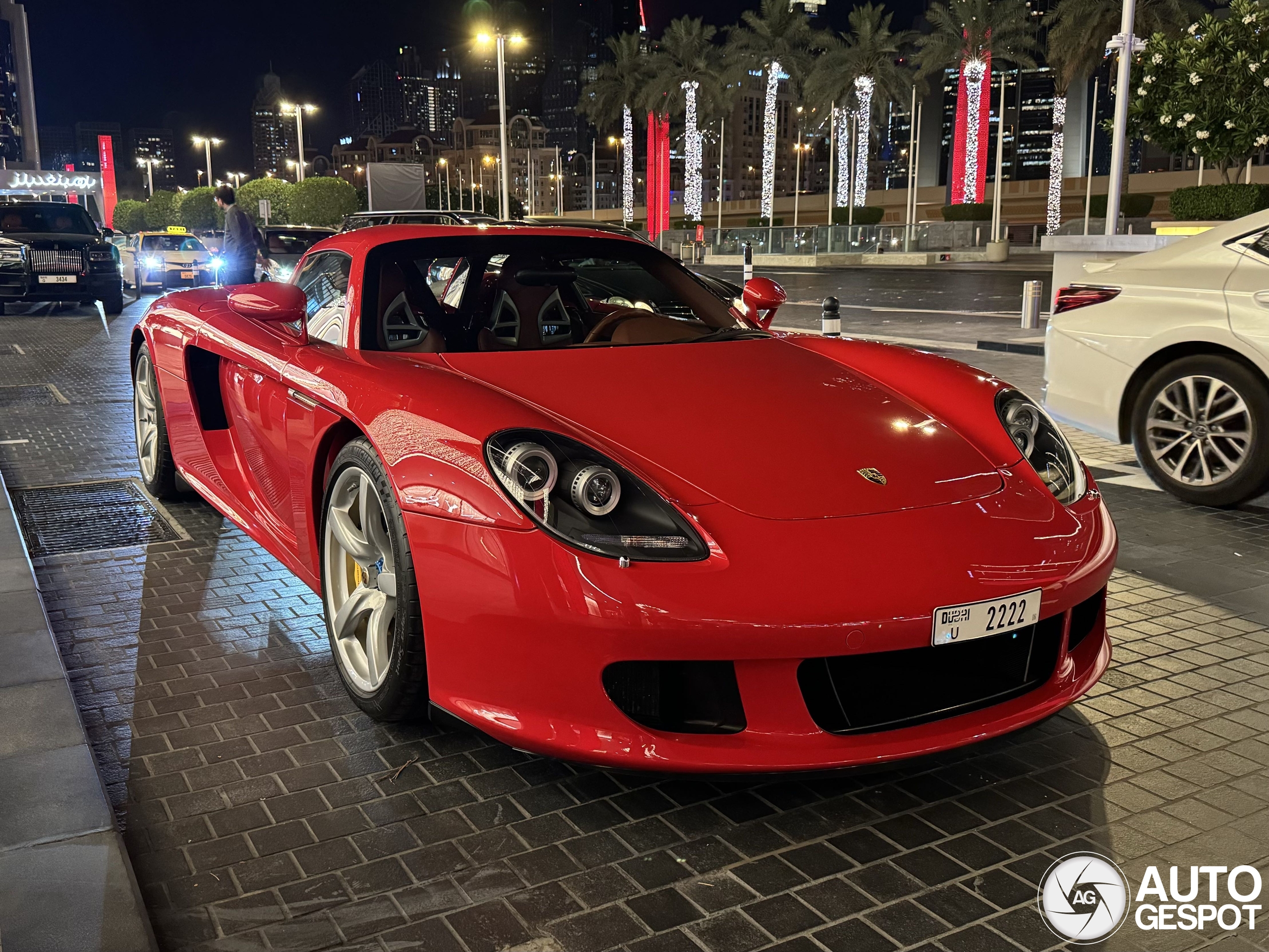 A red Porsche Carrera GT appears in Dubai